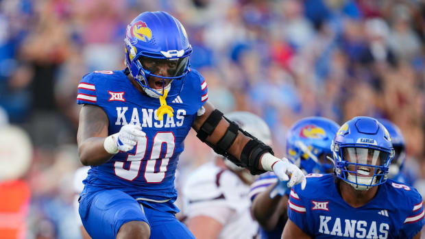 Sep 1, 2023; Lawrence, Kansas, USA; Kansas Jayhawks linebacker Rich Miller (30) and defensive lineman Austin Booker (9) celebrate after a play during the first half against the Missouri State Bearsa at David Booth Kansas Memorial Stadium. Mandatory Credit: Jay Biggerstaff-USA TODAY Sports  